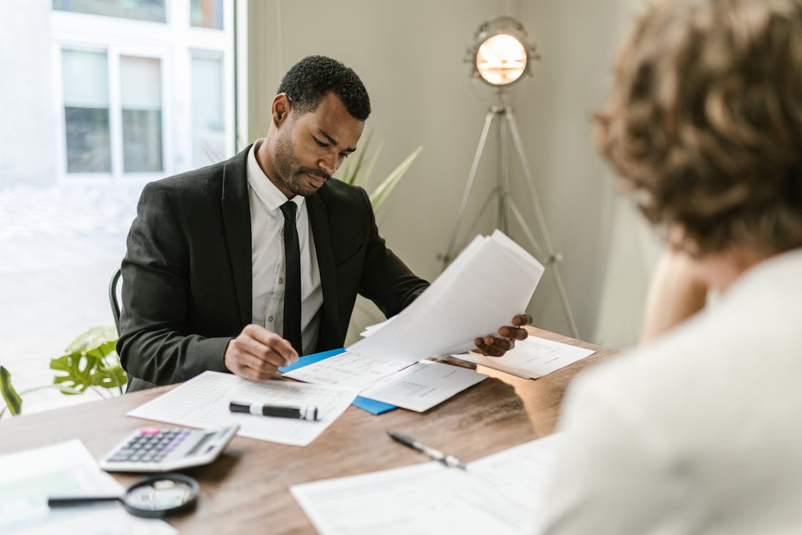 Auditor reviewing financial documents with client